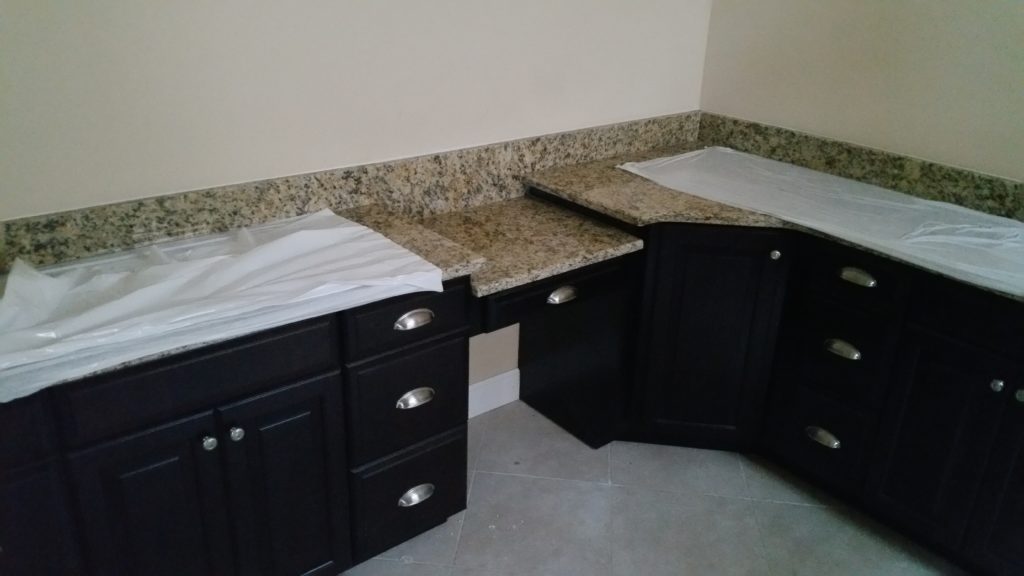 A vanity desk positioned beside a corner cabinet. 