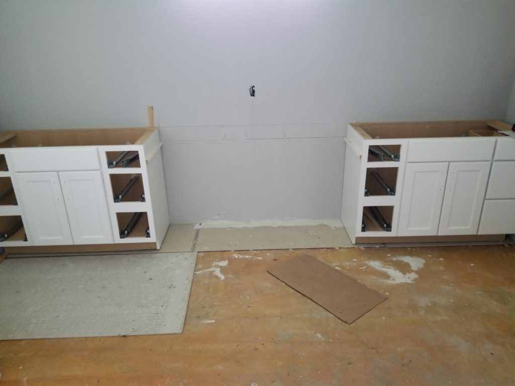 Two installed vanities with a gap left for the vanity desk.